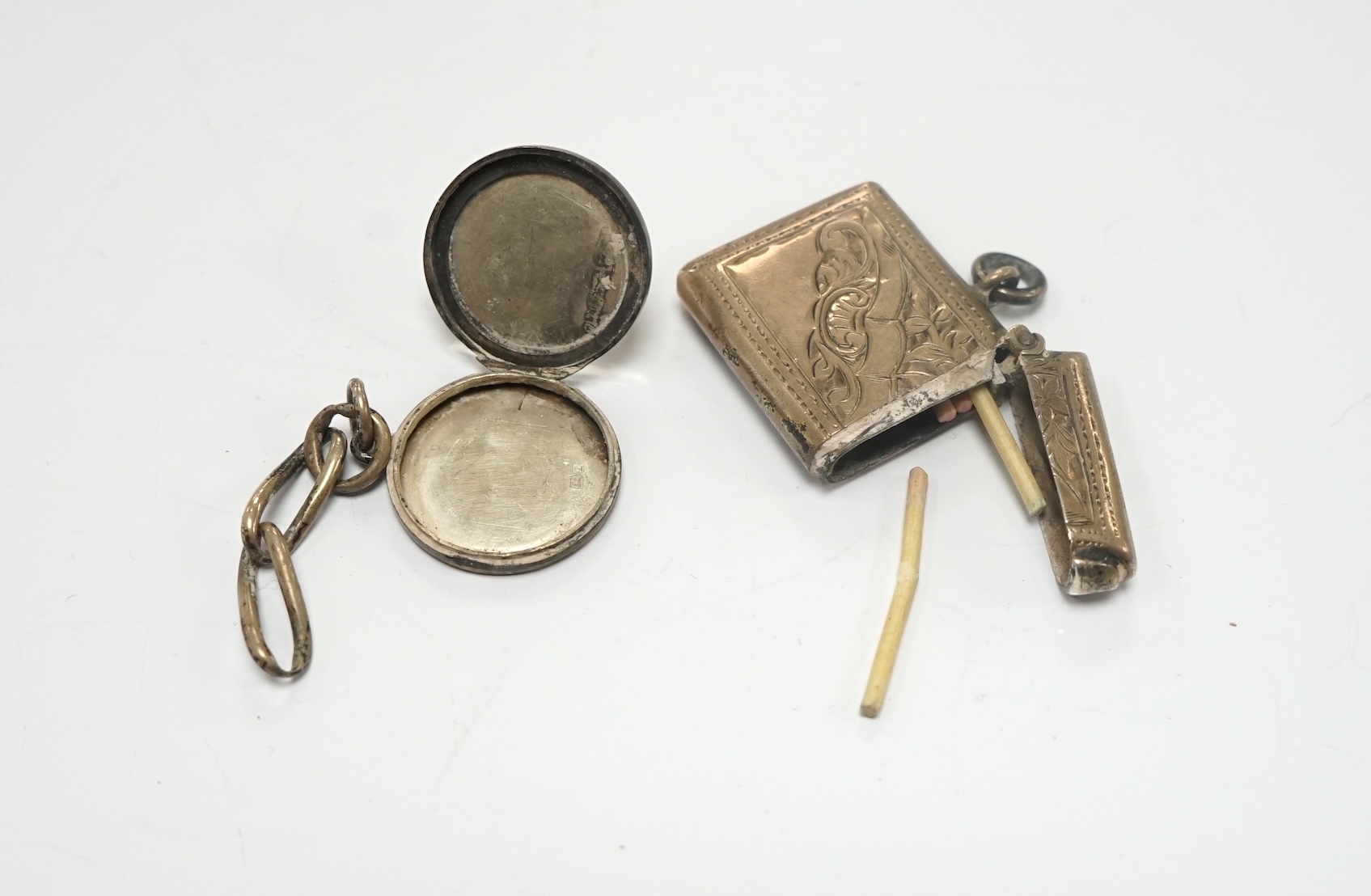 A cased set of twelve late Victorian silver bright cut engraved teaspoons and tongs, by Josiah Williams & Co, London, 1898, together with a silver locket and vesta case. Condition - fair to good